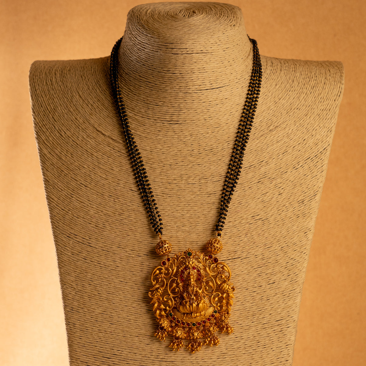 KARUNA GOLD TONED ANTIQUE FINISH TEMPLE NECKLACE WITH EARRINGS NL191