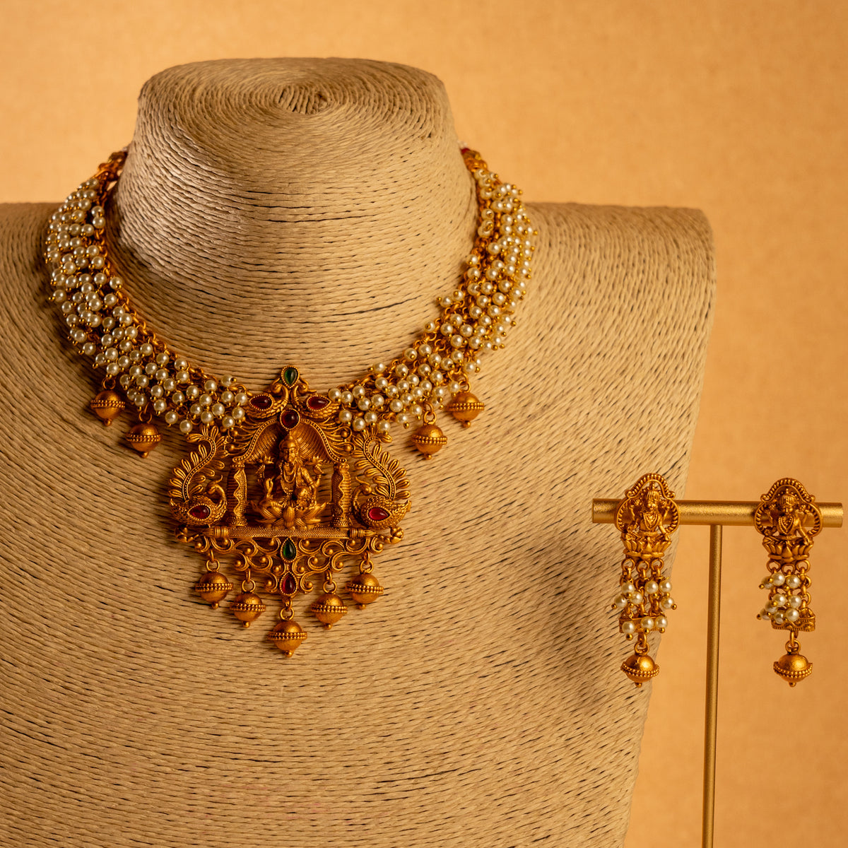NIRANJANA GOLD TONED ANTIQUE FINISH TEMPLE NECKLACE WITH EARRINGS NL189